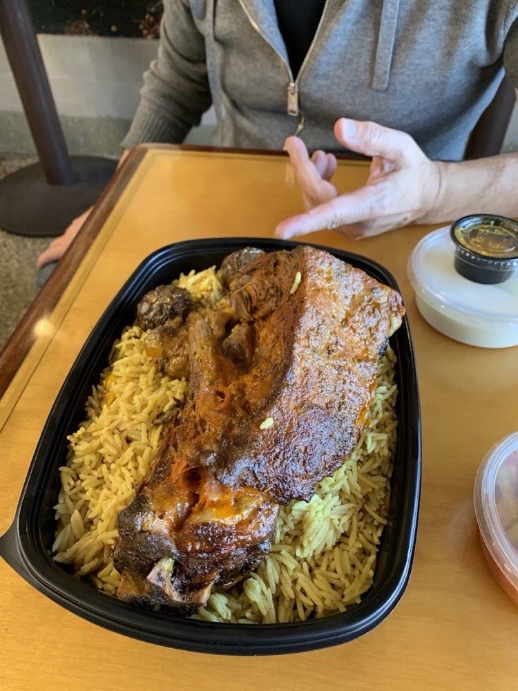 An order packed for pickup: lamb over saffron rice.